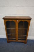 CAMEO FURNITURE, A 20TH CENTURY WALNUT BOOKCASE, with double glazed doors, raised on bracket feet,