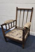 A 19TH CENTURY ROSEWOOD BOBBIN TURNED ARMCHAIR, with brass caps and castors, width 69cm x depth 76cm