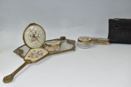 A BOX OF VINTAGE DRESSING TABLE ITEMS comprising a hand mirror, two brushes, a tray, a lidded pot,