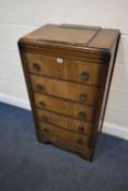 AN EARLY 20TH CENTURY OAK CHEST OF FIVE DRAWERS, with a small mirrored hinged storage compartment to