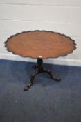 A GEORGIAN MAHOGANY SINGLE PLANK TILT TOP TABLE, the carved pie crust dish top raised on a turned