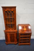 A REPRODUCTION YEW WOOD BUREAU, the fall front door enclosing a fitted interior, over four