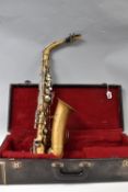 A CASED VINTAGE BUESCHER 'ARISTOCRAT' ALTO SAXOPHONE, serial no. 599396, painted in a gold colour on
