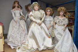 A GROUP OF PORCELAIN DOLLS, comprising seven dolls all in the style of wedding attire, height of