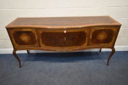 A REPRODUCTION FRENCH WALNUT SERPENTINE SIDEBOARD, fitted with four cupboard doors, raised on