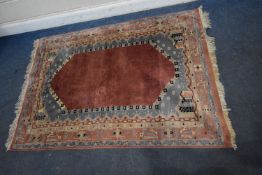 A PINK GROUND RECTANGULAR WOOLLEN RUG, with repeating geometric patterns, 183cm x 130cm, condition