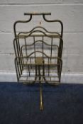 A 19TH CENTURY BRASS REVOLVING CANTERBURY, raised on three splayed legs with hairy paw feet,