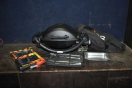 A WEBER TABLE TOP GAS BARBECUE with domed top, cover and two sets of utensils (appears unused and