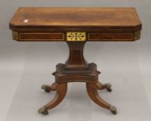A Regency brass inlaid rosewood card table. 91.5 cm wide.