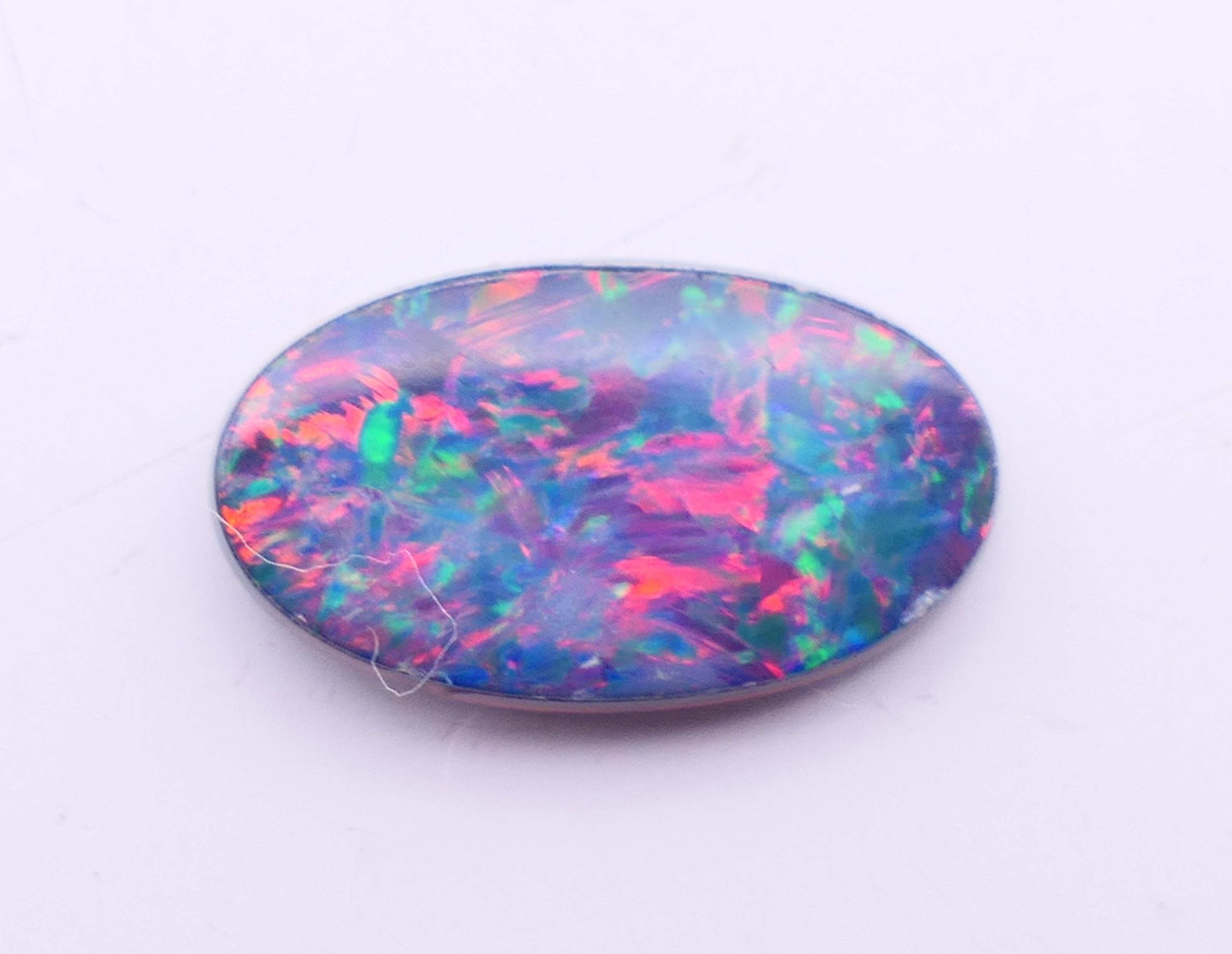 Two loose black opals and a white opal. Black opals 2 cm high and 1.5 cm high, white opal 2 cm x 1. - Image 5 of 8