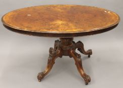 A Victorian burr walnut loo table. 135 cm long.