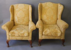 Two early 20th century upholstered wingback armchairs. The larger 81 cm wide.
