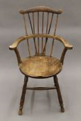 A 20th century comb-back Windsor chair. 60 cm wide.