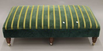 A large modern upholstered stool. 142 cm long, 76 cm wide.