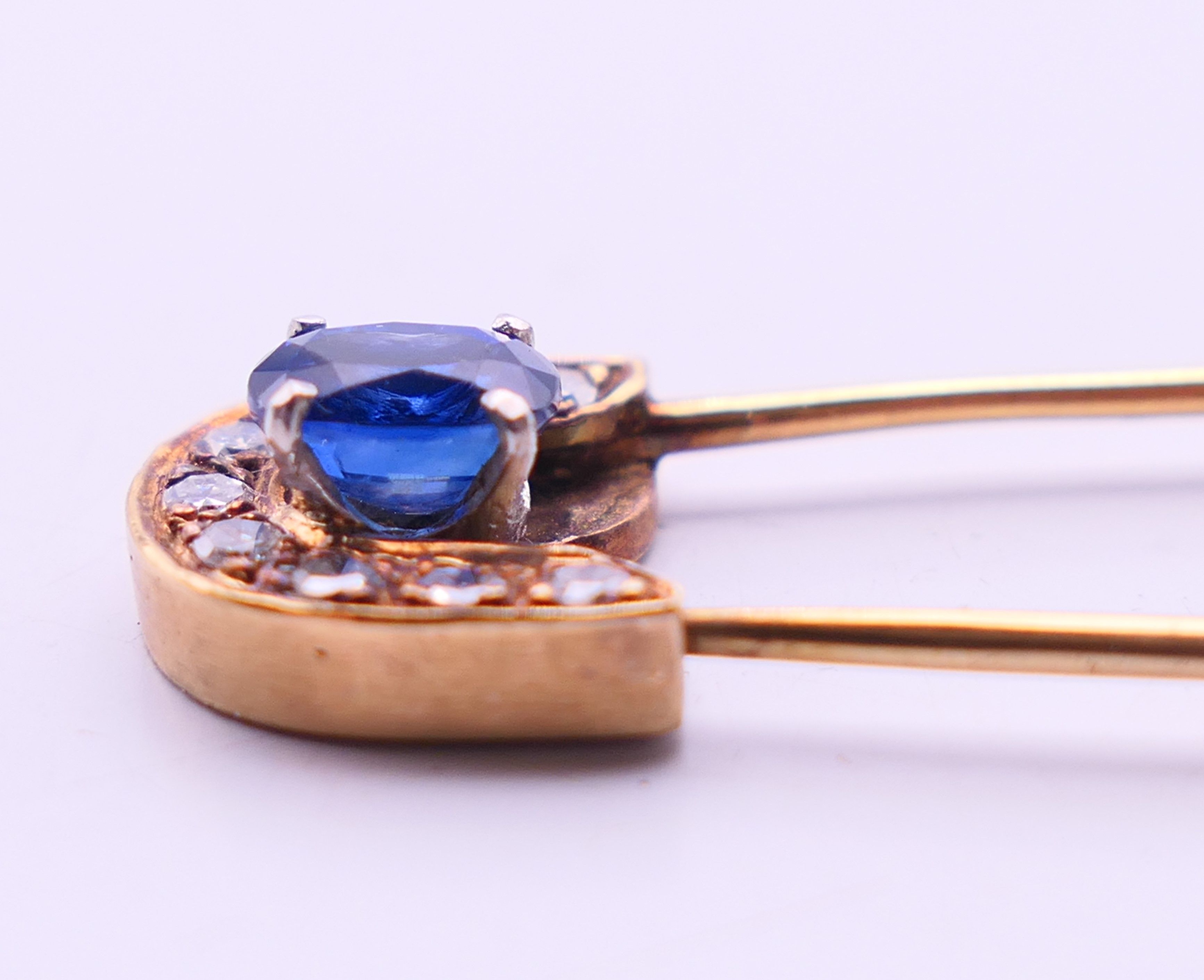 A 9 ct gold stone set safety pin form brooch. 6 cm high. 4.8 grammes total weight. - Image 5 of 6
