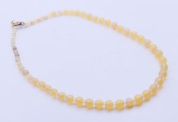 An opal graduated bead necklace with 9 ct gold clasp. 40 cm long.