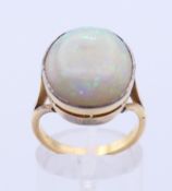 A 15 ct gold and opal ring. Opal 1.8 cm high. Ring size O.