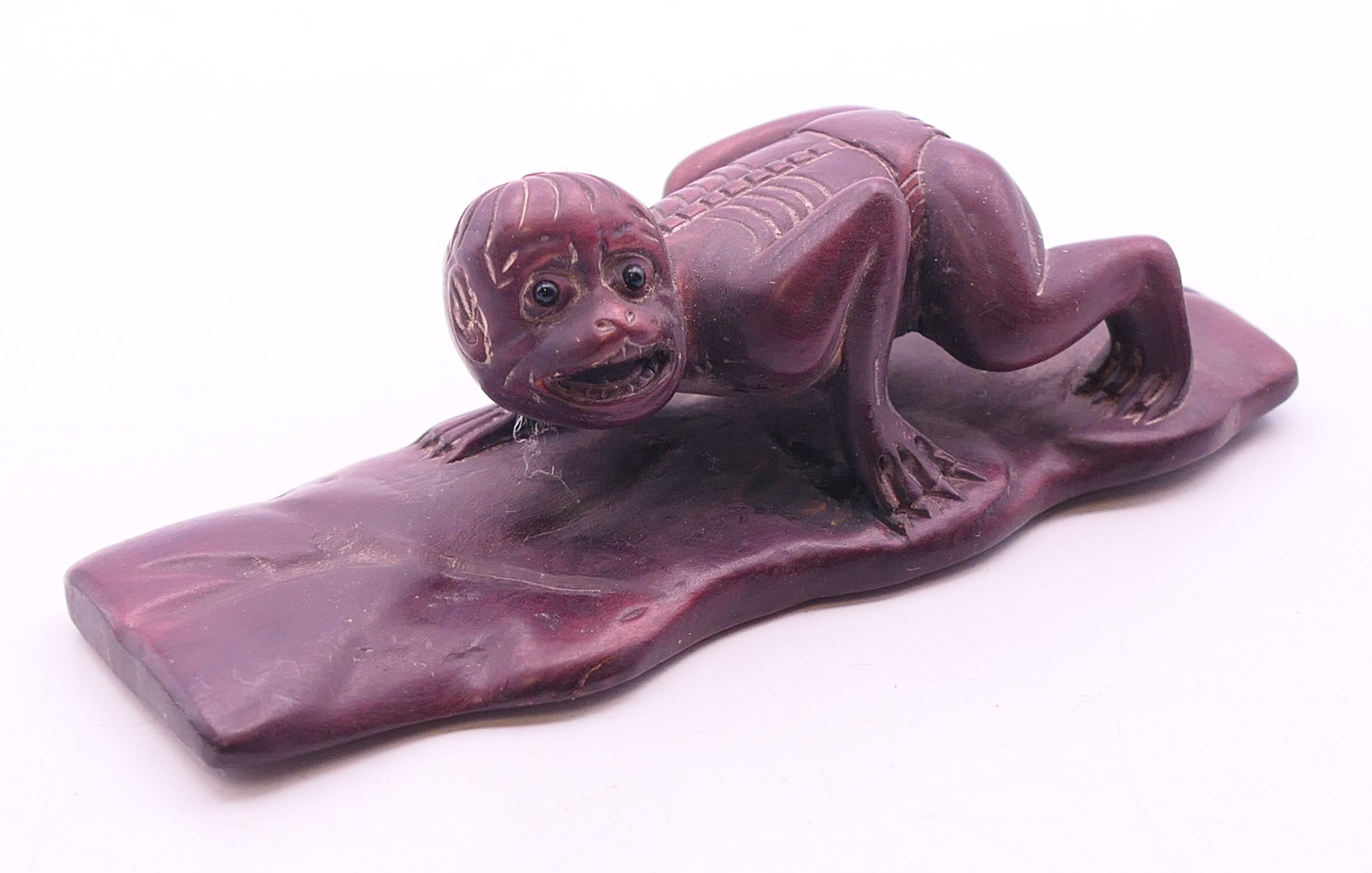 A carving of monkey on a leaf. 10 cm x 3.5 cm high.