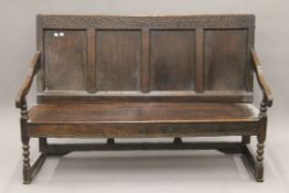 An 18th and later century oak four-panelled settle. 151 cm wide.