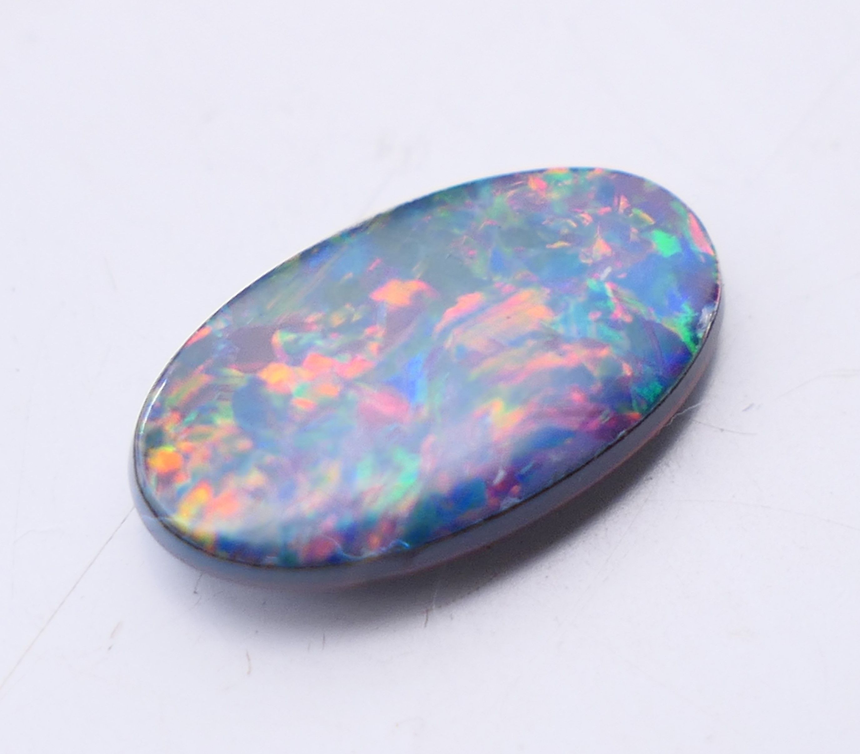 Two loose black opals and a white opal. Black opals 2 cm high and 1.5 cm high, white opal 2 cm x 1. - Image 6 of 8