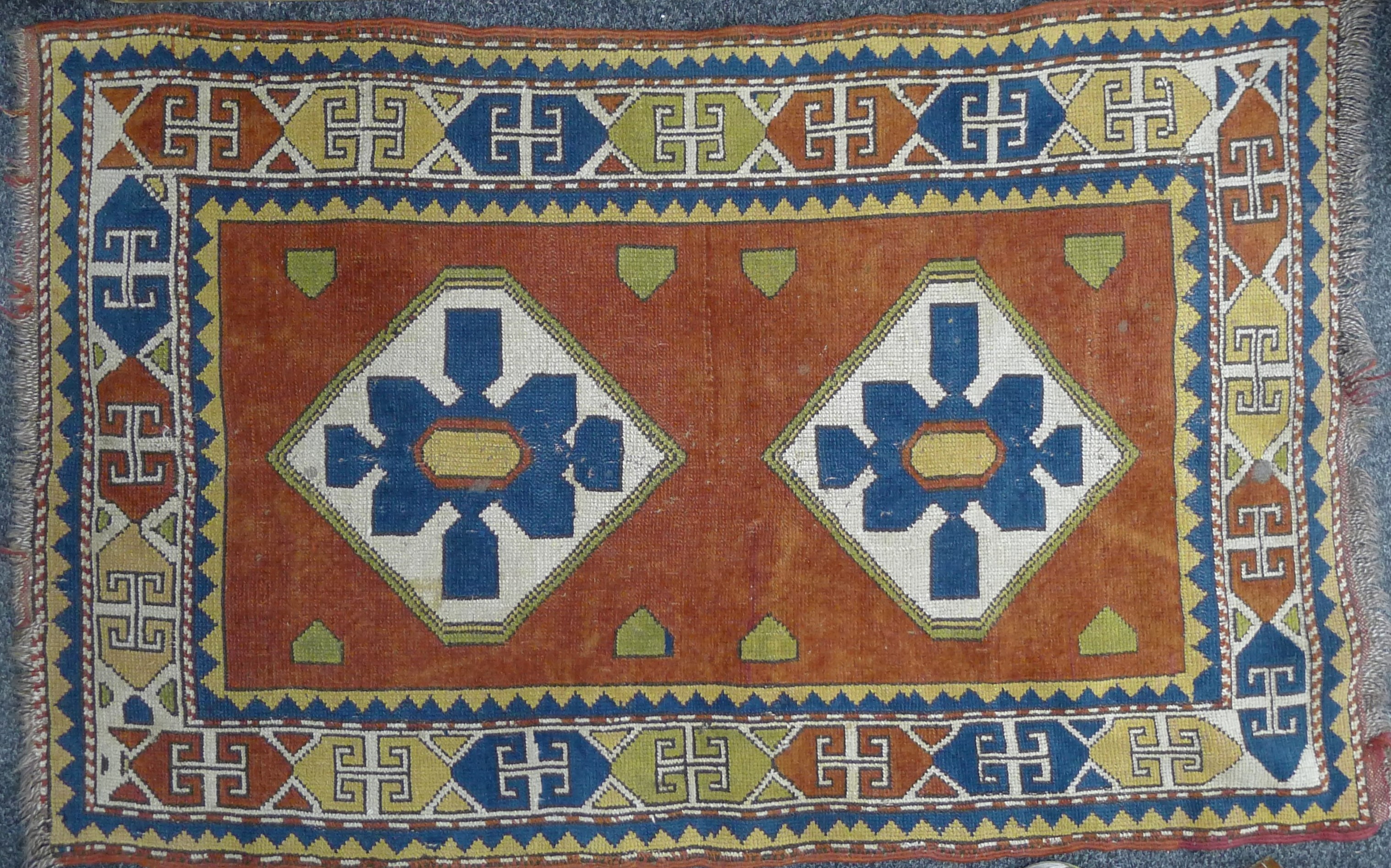An Eastern red ground rug. 95 x 140 cm.