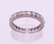 A platinum and diamond eternity ring. Ring size L/M.