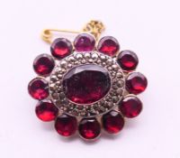 A garnet and marcasite brooch. 2.5 cm x 2 cm.