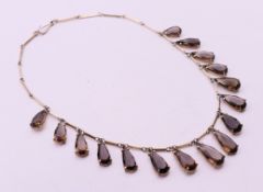 A silver and smoky quartz necklace. 39 cm long.
