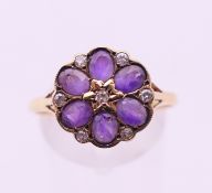 A 9 ct gold, amethyst and diamond cluster ring. Ring size U.