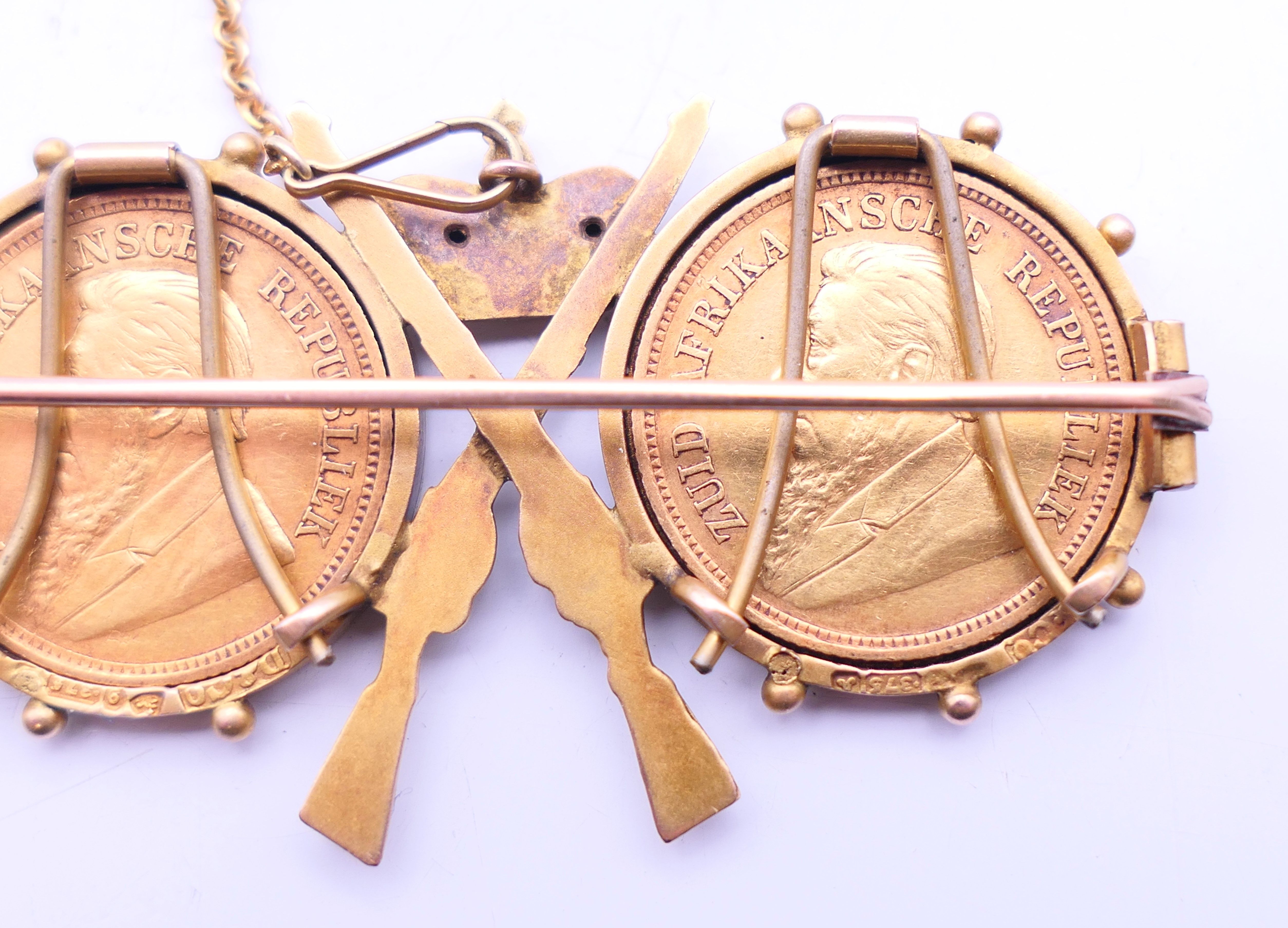 A 9 ct gold military brooch set with two 1895 South African half-pond coins. 5 cm wide x 3 cm high. - Image 4 of 6