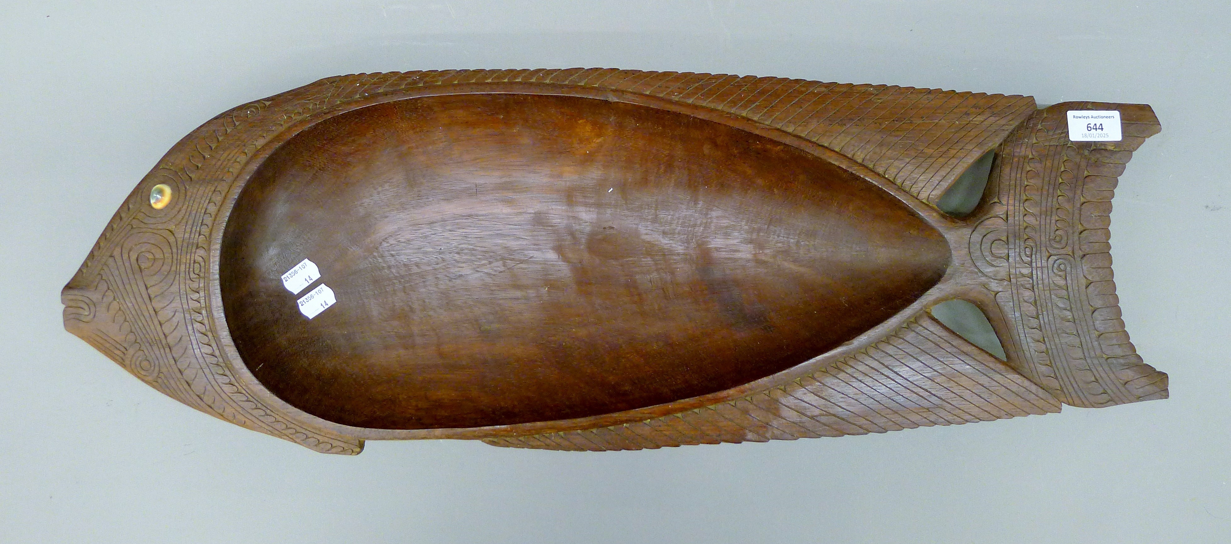 A large Solomon Islands wood bowl in the form of a fish with shell eye. 77 cm long.