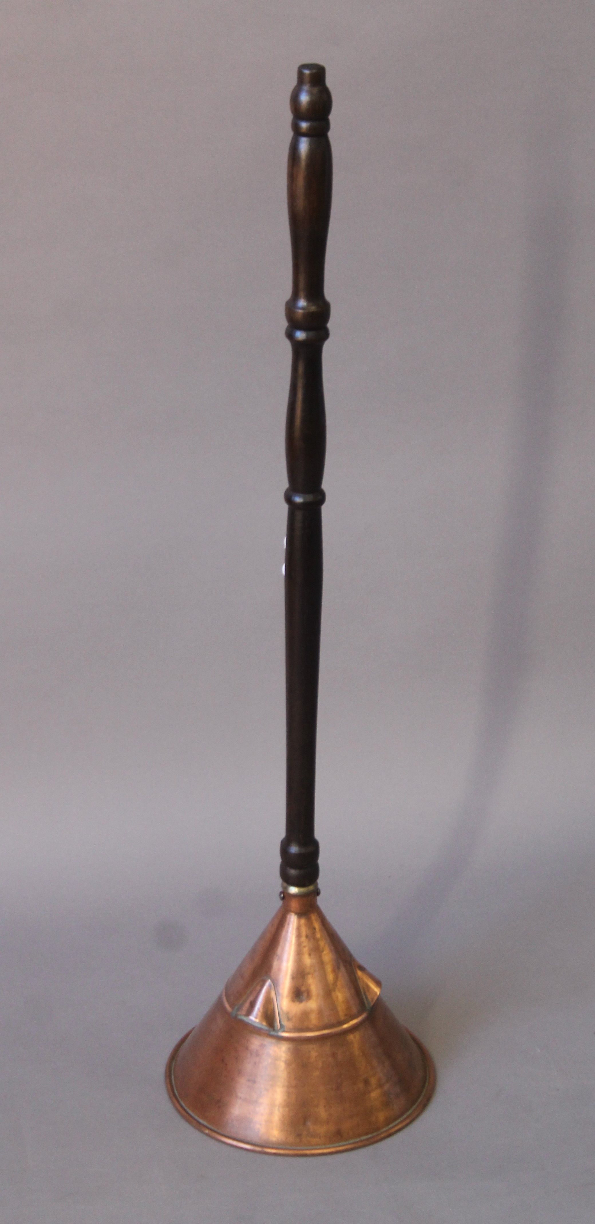 An early 20th century copper laundry posser. 88 cm high.