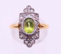 An 18 ct gold diamond and peridot ring. Ring size O.