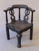 A 19th century carved oak corner chair. 70 cm wide.