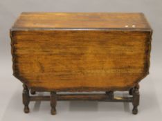 An early 29th century oak piecrust barley twist gate-leg table. 102 cm wide.