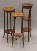 Three Edwardian mahogany torcheres. The largest 107.5 cm high.