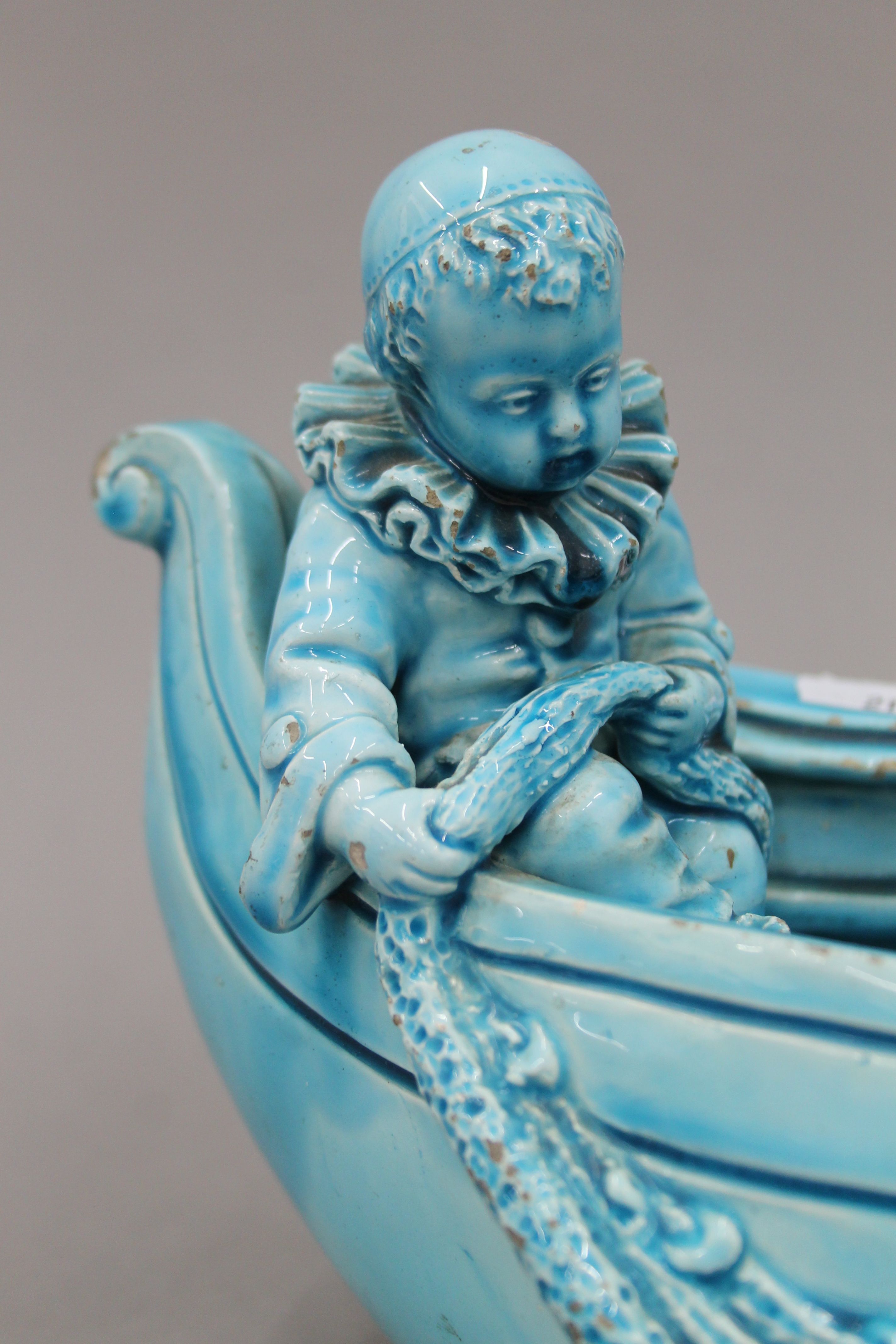 A 19th century blue ground pottery centrepiece formed as clowns in a boat. 31 cm long. - Image 3 of 8