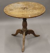 A George III inlaid oak tilt-top tripod table. 77.5 cm diameter.