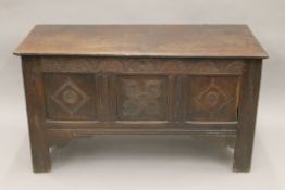 An 18th century carved oak three-panel coffer. 119 cm long.