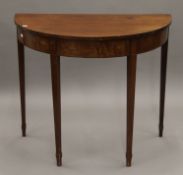 A mahogany side table and a mahogany demi-lune table. The latter 91 cm wide.
