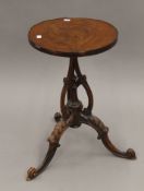 A Victorian walnut tripod side table. 34 cm diameter.