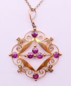 An Edwardian 9 ct gold, garnet and pearl pendant, on a 9 ct gold chain. Pendant 3.