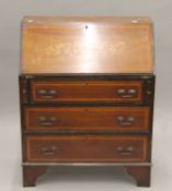 An Edwardian inlaid mahogany bureau. 75.5 cm wide.