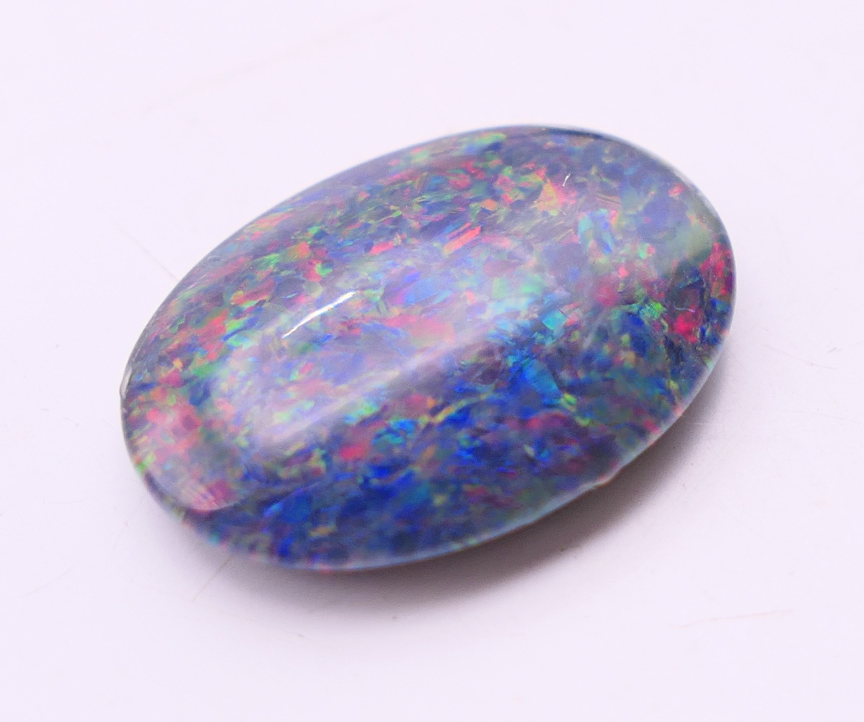 Two loose black opals and a white opal. Black opals 2 cm high and 1.5 cm high, white opal 2 cm x 1. - Image 4 of 8