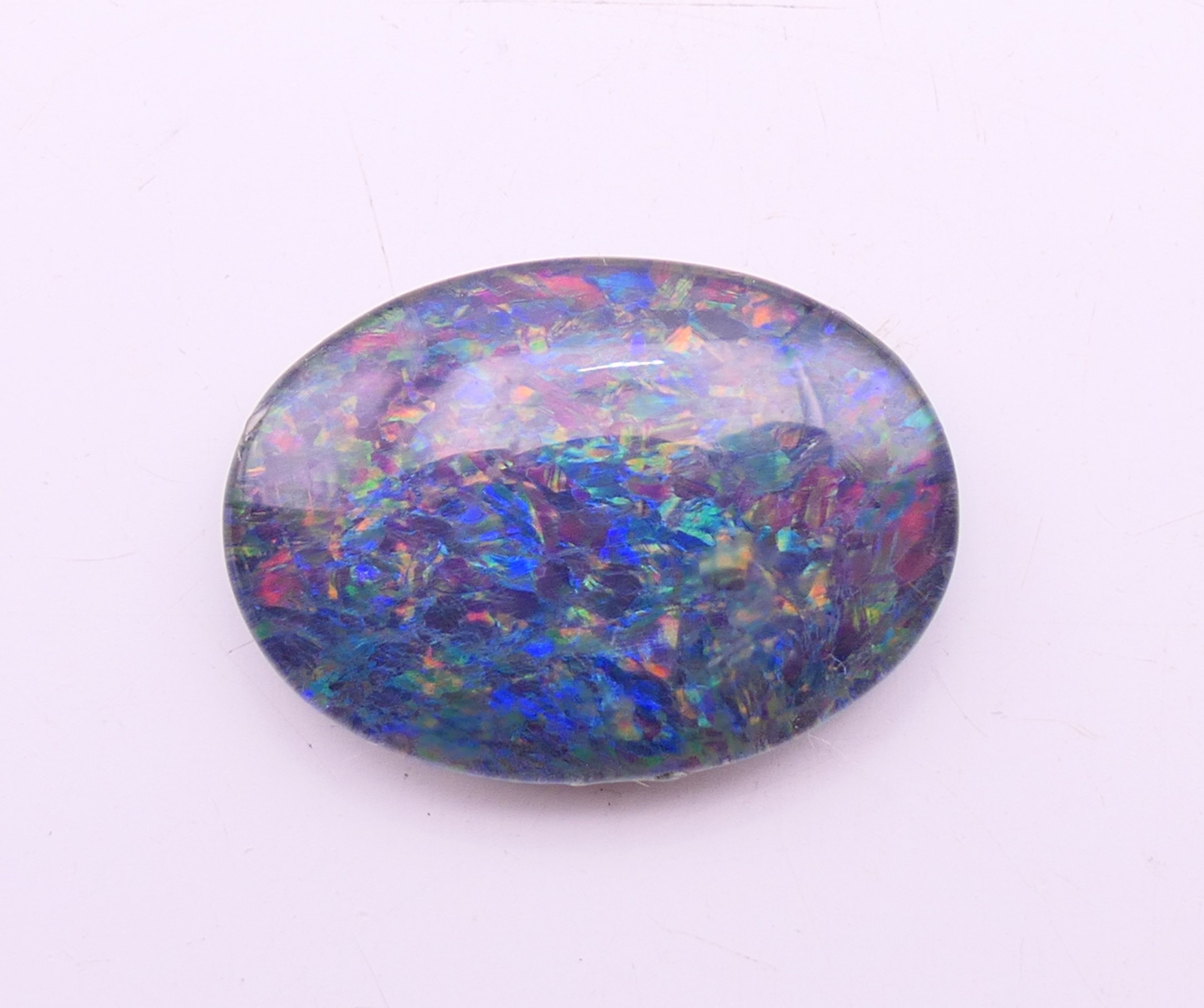 Two loose black opals and a white opal. Black opals 2 cm high and 1.5 cm high, white opal 2 cm x 1. - Image 3 of 8