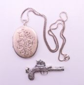 A silver locket on chain and a silver gun whistle pendant. Locket 5.