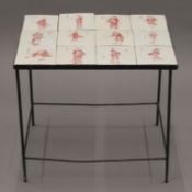 A coffee table set with tiles depicting Japanese figures. 52 cm wide.