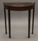 An early 20th century inlaid mahogany demi-lune table. 67.5 cm wide.