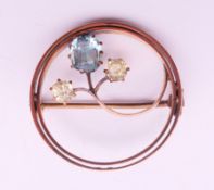 A 9 ct gold gem set brooch. 2.5 cm diameter. 4.3 grammes total weight.