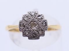 An 18 ct gold, platinum and diamond ring. 2.1 grammes total weight. Ring size O/P.